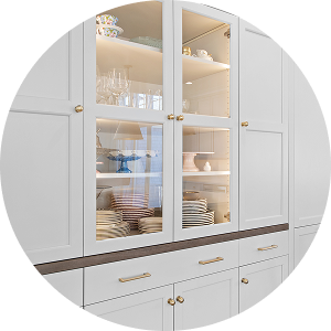 Built-in cabinetry with glass display, shaker doors, and brass hardware by California HarborCrest Kitchen Design